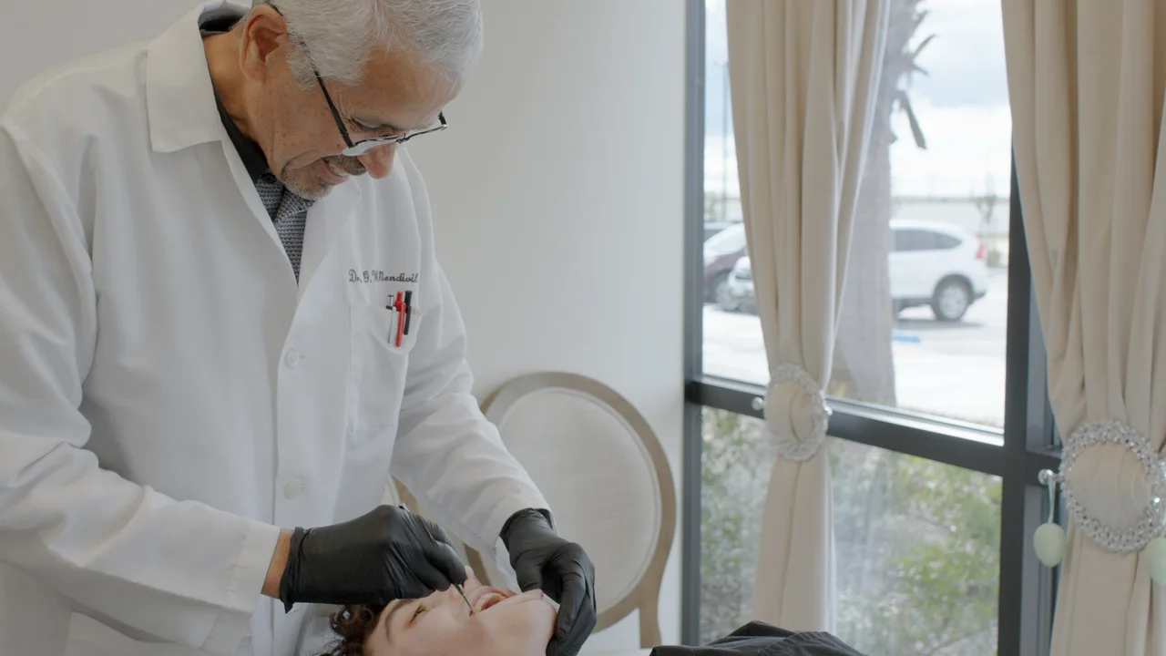 Dr. Mendivil in consultation with a patient