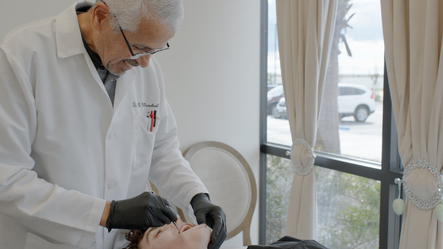 Dr. Guy Mendivil providing orthodontic care in a private treatment room