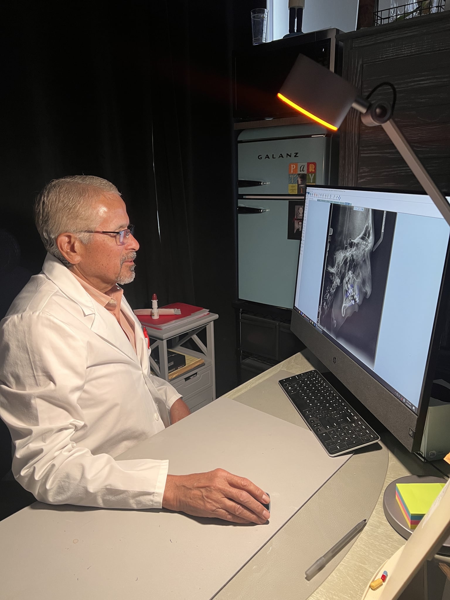 Dr. Guy Mendivil reviewing orthodontic X-rays in his Bakersfield office