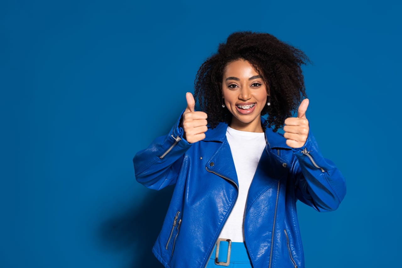 Teen smiling, wearing clear aligners